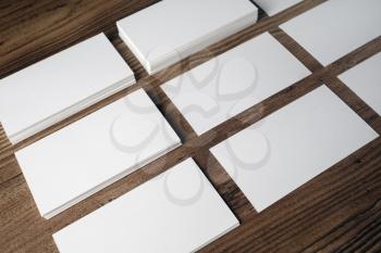 Photo of blank white business cards on wood background.