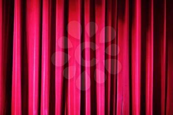 Red stage curtain with spotlight. Abstract background.