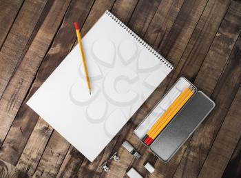 Photo of blank stationery set. Corporate identity template on wood table background. Mockup for design portfolios. Flat lay.