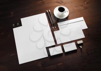 Blank corporate stationery set on wood table background. Template for branding identity.