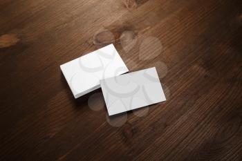 Photo of blank business cards stack on wood table background. Template for branding identity.