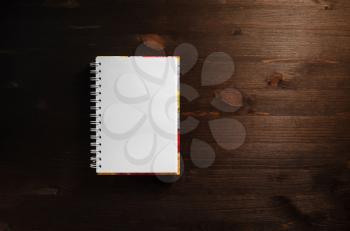 Blank notepad on wood table background. Space for text. Flat lay.