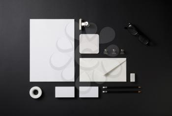 Blank stationery set on black paper background. Paperwork template. Responsive design mockup. ID template. Top view.