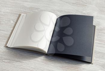 Mockup of opened blank booklet on light wooden background. Responsive design template.