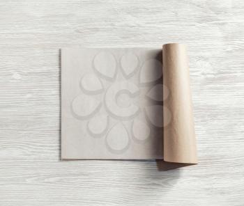 Opened blank magazine or brochure on light wooden background. Flat lay.