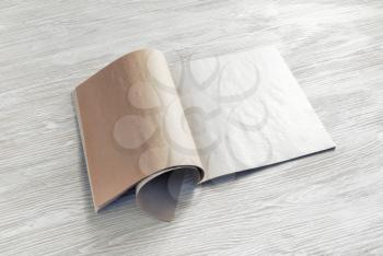 Blank magazine pages or booklet on wooden table background.