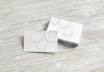 Blank business cards on light wooden background. Template for branding identity. Mockup for ID. Studio shot.
