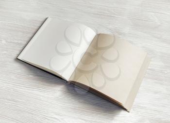Blank notepad or book on light wooden background. Mockup for your design.
