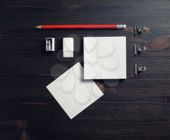 Blank corporate stationery set on wooden background. Notes, pencil, eraser and sharpener. Flat lay.
