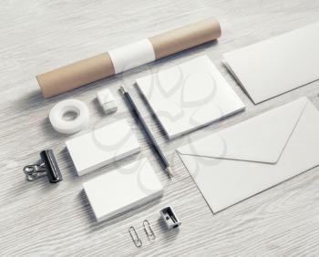 Photo of blank stationery set on light wooden background. Corporate identity mock up for placing your design.