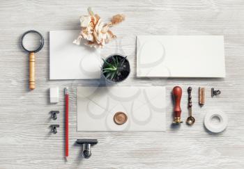 Photo of blank vintage stationery set on light wooden background. Top view. Flat lay.