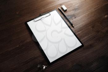 Stationery mock up. Clipboard with blank letterhead, pencil and eraser on wooden background. Responsive design template.