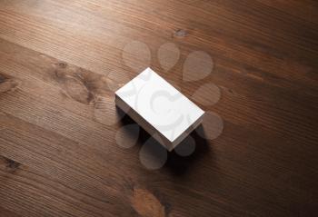 Stack of blank business cards on wood table background.