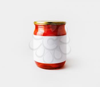 Red paprika canned in a jar with blank label. Pickled vegetables. Responsive design mockup.