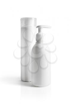 Blank cosmetic containers on white background. Isolated with clipping path. Dispenser and shaving gel.