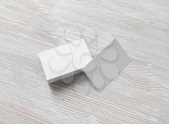 Photo of blank business cards stack on light wooden background. Template for branding identity.
