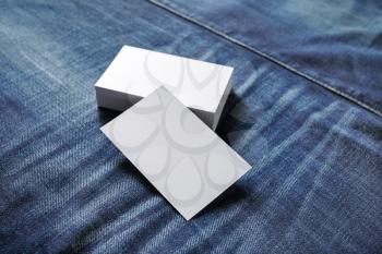Photo of blank business cards on denim background. Template for ID.