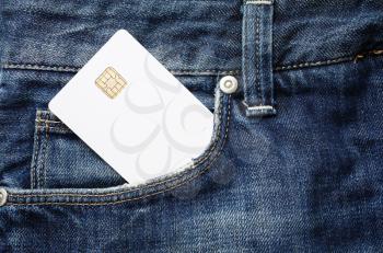 Blank credit card in jeans pocket. White chip card.