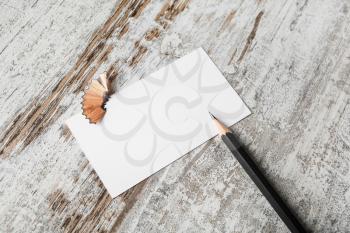 Blank business card and pencil on wooden table background. ID mock up. Top view.