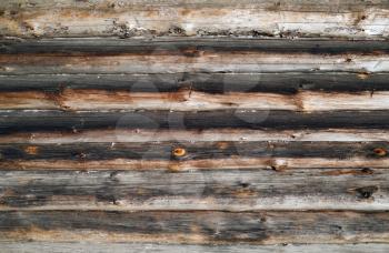Old wooden logs wall background. Rustic weathered wood texture.