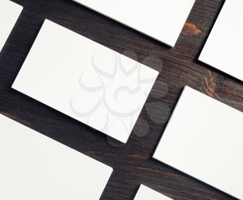 Photo of blank white business cards on wooden background. Template for design presentations and portfolios. Copy space for text.