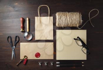 Corporate identity template. Blank kraft paper stationery mock up on wood table background. Flat lay.