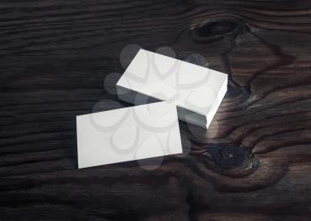 Photo of blank business cards on wood table background. Branding mockup. Copy space for text.