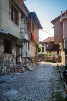 Sozopol, Bulgaria - September 03, 2014: Old town Sozopol at Black Sea Coast, Bulgaria. Street, ancient architecture and cobbled stone pavement. Architectural and Historic Complex. Vertical shot.