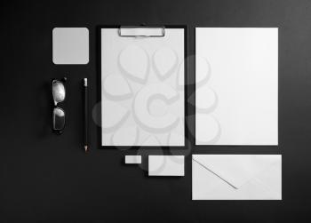 Photo of blank stationery set on black paper background. Corporate identity template. Responsive design mockup.