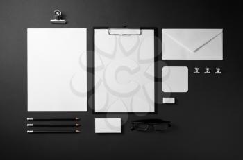 Branding stationery mockup on black paper background. Blank objects for placing your design. Top view.