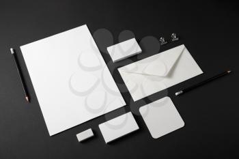Blank stationery set with plenty of copy space for placing your design. Corporate identity mockup on black paper background.