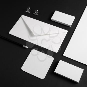 Branding identity mock up. Blank corporate stationery template on black paper background.