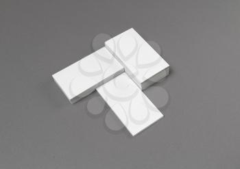 Empty blank business cards on gray paper background.