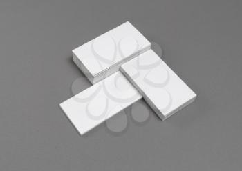 Photo of blank business cards with soft shadows on gray background. For design presentations and portfolios. Mock-up for ID.
