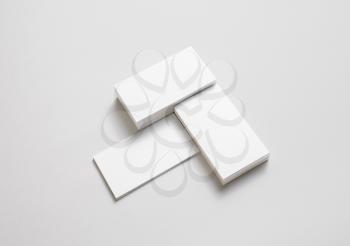 Blank white business cards with soft shadows on paper background. Mockup for branding identity. Template for placing your design.