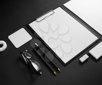 Corporate stationery mockup. Branding ID elements. Blank objects on black paper background.