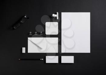 Blank stationery set on black paper background. ID template. Mockup for branding identity for designers. Top view.