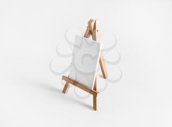 Blank business cards on wooden stand at white paper background. Mockup for placing your design.