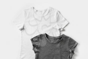 Gray and white t-shirts used as design template. Tshirt on white paper background.