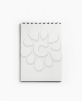 Blank notepad for sketching on white paper background. Album with spiral. Free space. Flat lay.
