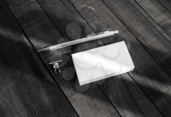 Blank business cards and pen on wood background. Photo of blank stationery.