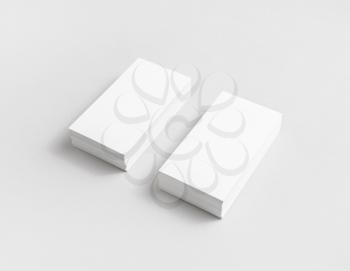 Photo of blank white paper business cards with soft shadows. Mock up for branding identity for designers.