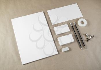 Photo of blank stationery set on craft paper background. Corporate identity template. Responsive design mockup.