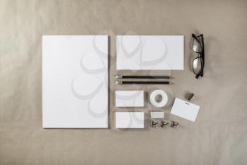 Photo of blank stationery set on craft paper background. Corporate ID template. Responsive design mockup. Top view.