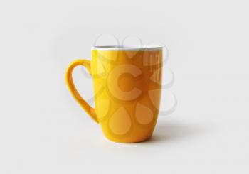 Blank yellow tea cup or coffee mug. Responsive design mockup.