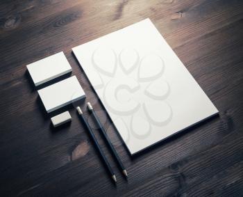 Blank corporate stationery set on wood table background. Template for branding identity.