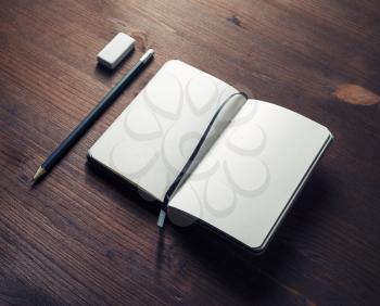 Blank diary, pencil and eraser on wooden background. Responsive design mockup. Blank objects for placing your design.