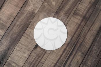 Blank white beer coaster on wooden background. Responsive design mockup. Flat lay.