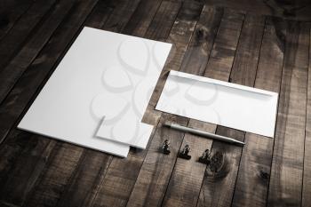 Photo of blank stationery set on wooden table background. Responsive design mockup. ID template. Top view.