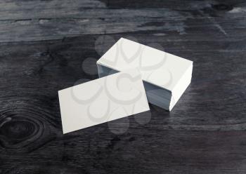 Photo of blank business cards on wood background. Mock-up for branding identity with plenty of copy space. Blank template for your design.